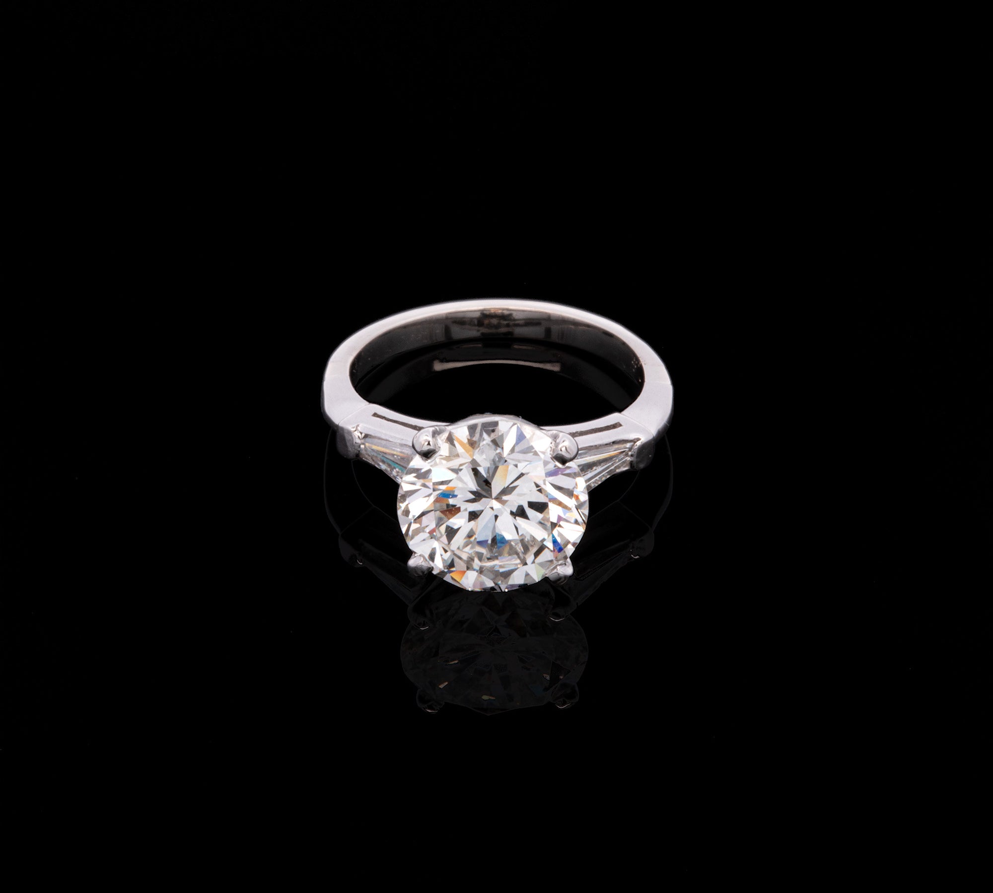 Platinum Round Brilliant Cut Diamond Solitaire Ring With Tapered Baguette Diamonds