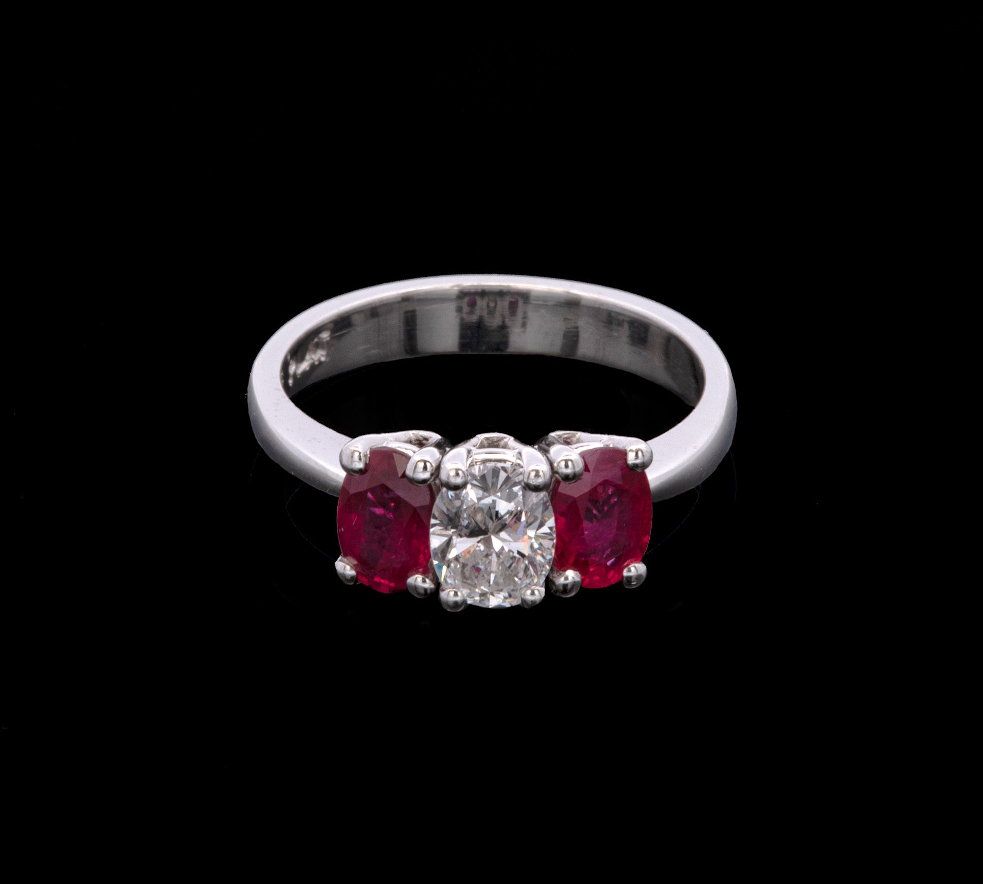 Platinum Three Stone Oval Diamond And Ruby Ring