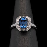18K White Gold Emerald Cut Sapphire And Baguette Diamond Halo Ring