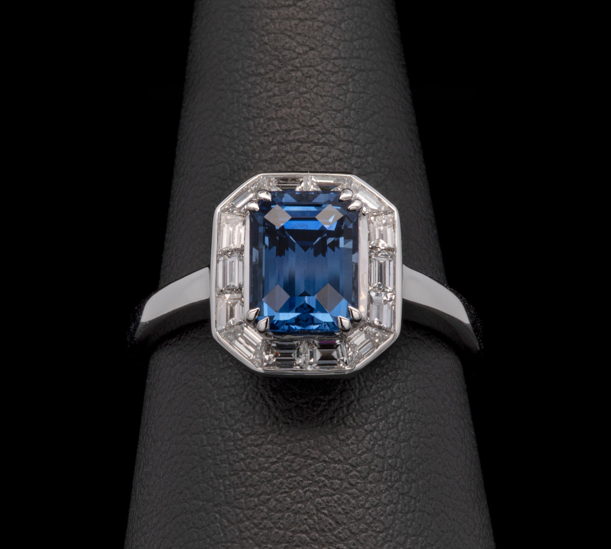 18K White Gold Emerald Cut Sapphire And Baguette Diamond Halo Ring
