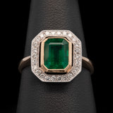 18K Yellow And White Gold Bezel Set Emerald Ring With Diamond Halo