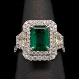 18K White Gold Emerald And Diamond Double Halo Ring With Light Fancy Yellow Trapezoid Cut Diamonds