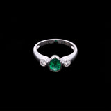 18K White Gold Bezel Set Oval Emerald And Round Diamond Ring