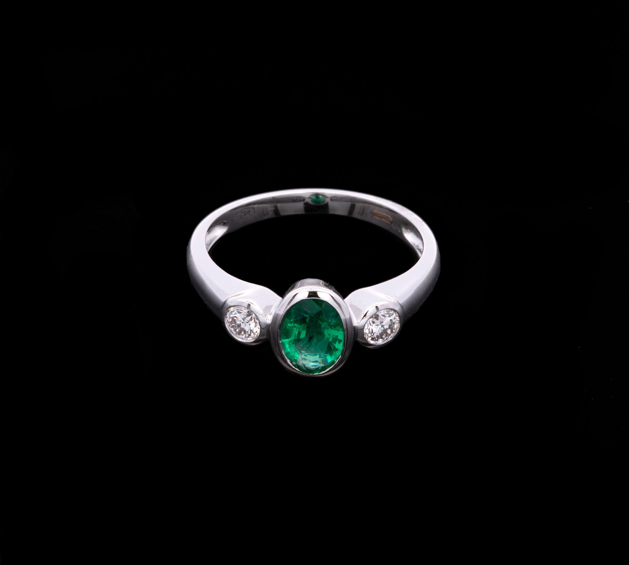 18K White Gold Bezel Set Oval Emerald And Round Diamond Ring