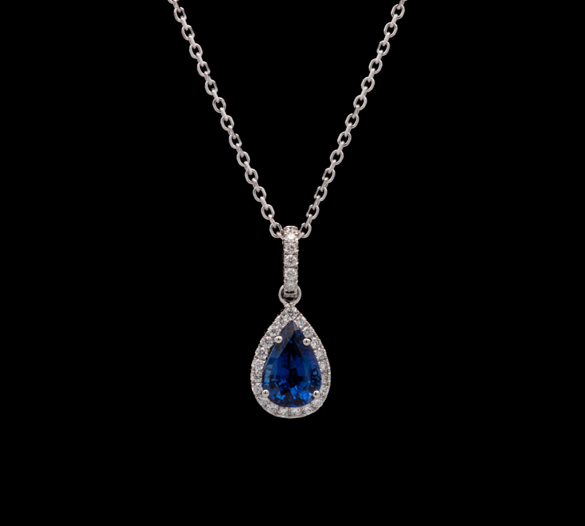 14K White Gold Ceylon Sapphire And Diamond Halo Pendant With 18 Inch Cable Chain.