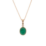 Gold necklace with a green emerald pendant on a white background