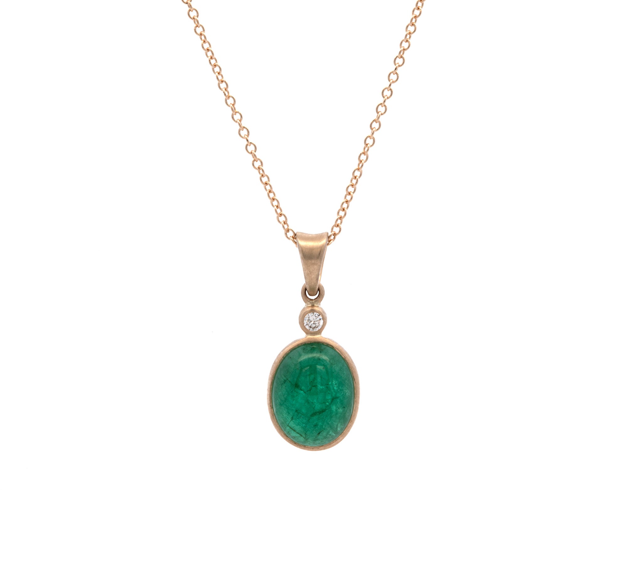 Gold necklace with a green emerald pendant on a white background