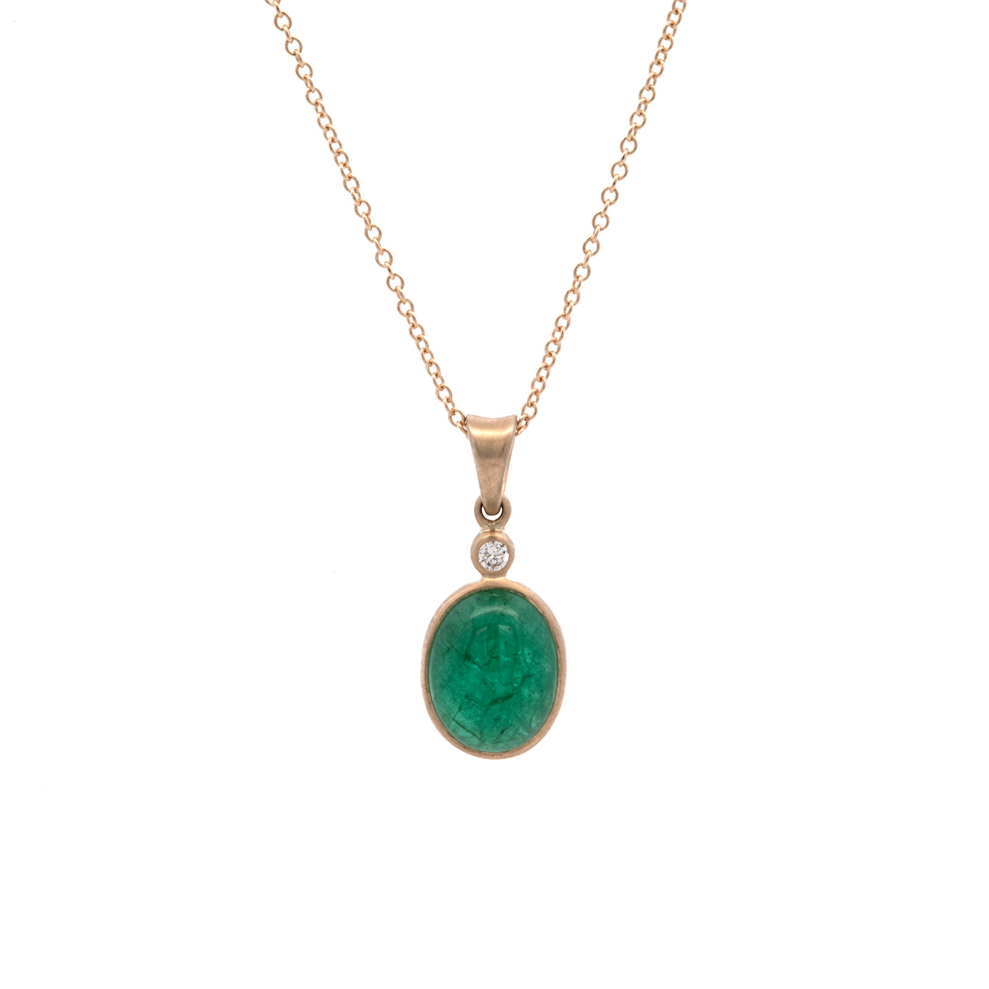 Gold necklace with a green emerald pendant on a white background