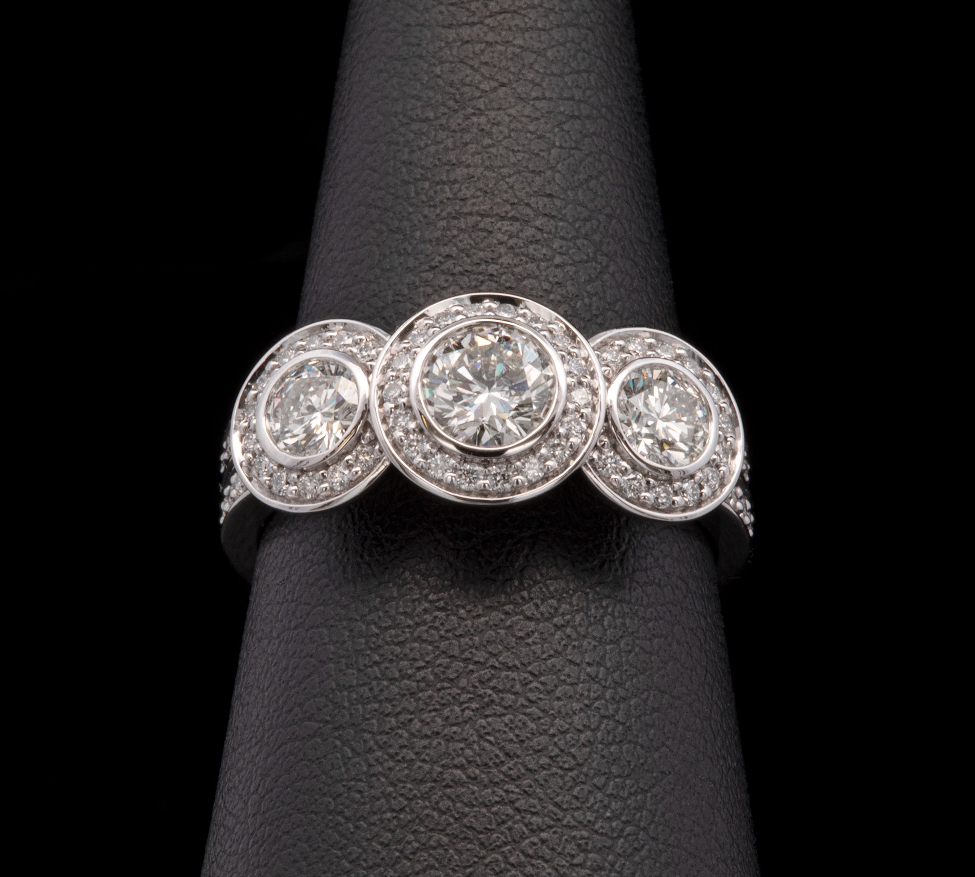 Custom Platinum Bezel Set Three Stone Engagement Ring With Diamond Halos And Matching Eternity Band